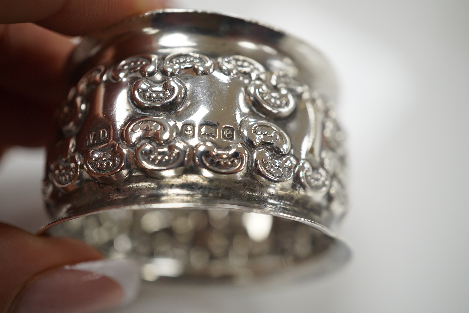 An Elizabeth II silver three piece condiment set, Sheffield, 1964, six assorted silver napkin rings and a stylish Austro Hungarian white metal pill box, by George Adam Scheid, 62mm. Condition - fair